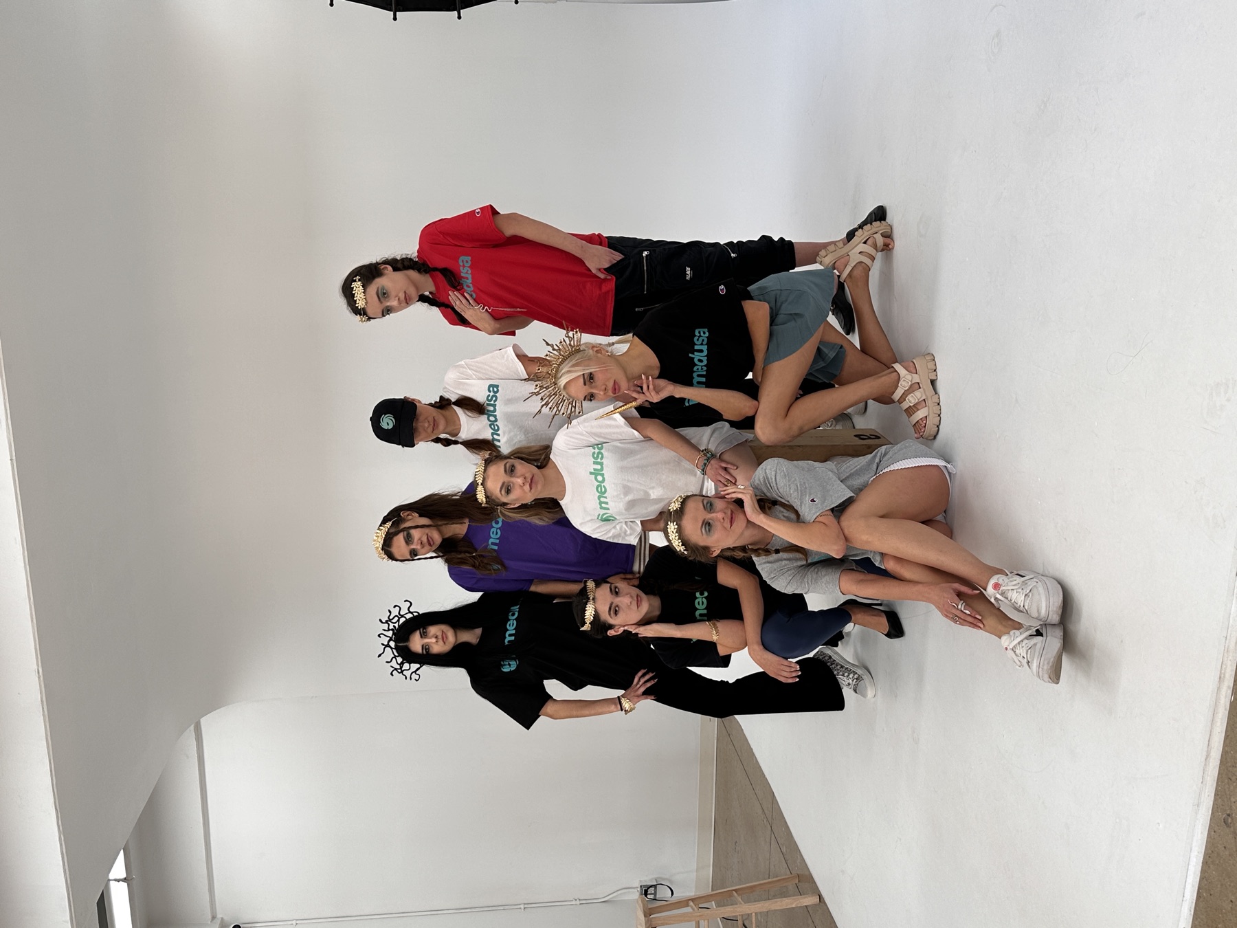 Studio shoot: eight models in Medusa tees wearing gold laurel crowns and a snake headpiece